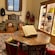 A showroom displaying leather purses, hats, books and coats